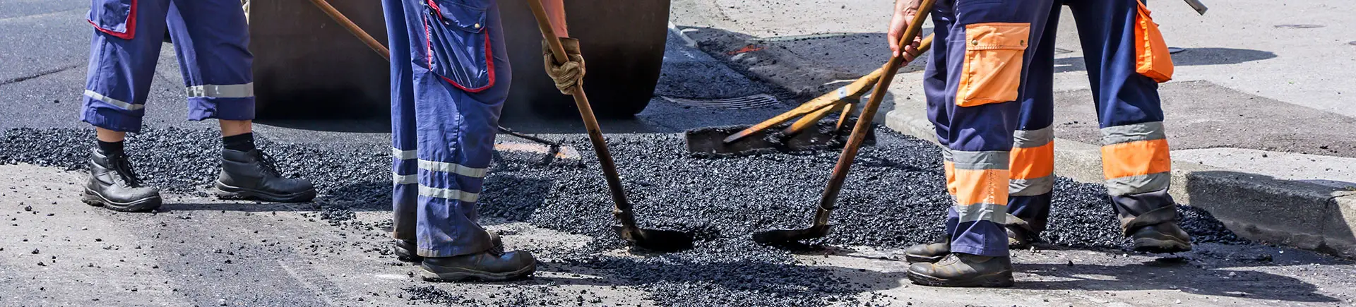 Crew carrying out a full-depth asphalt patch repair