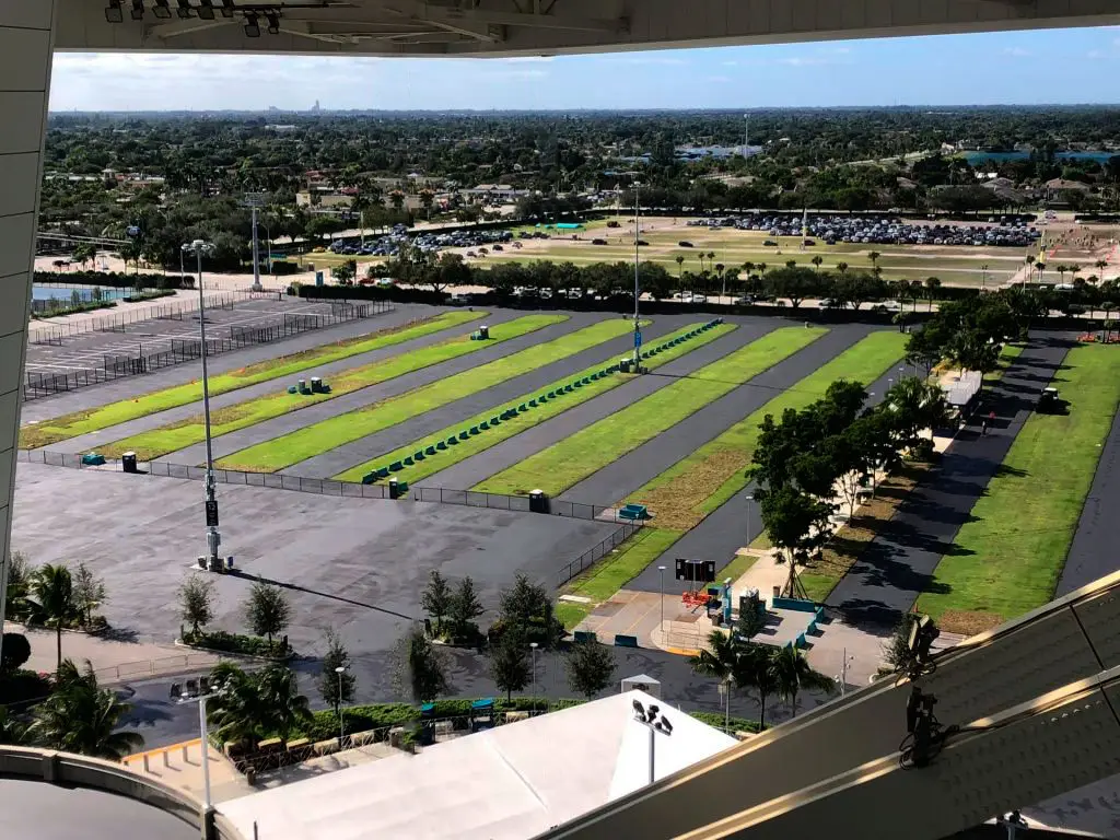 Striped parking areas with grass separation, viewed from the stadium