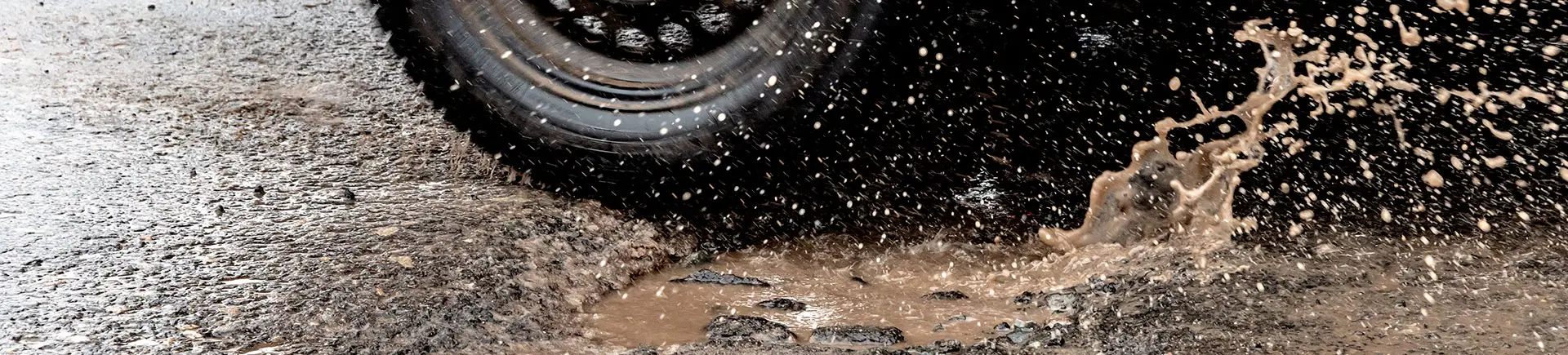 Pothole cut out and repaired with compacted hot mix asphalt